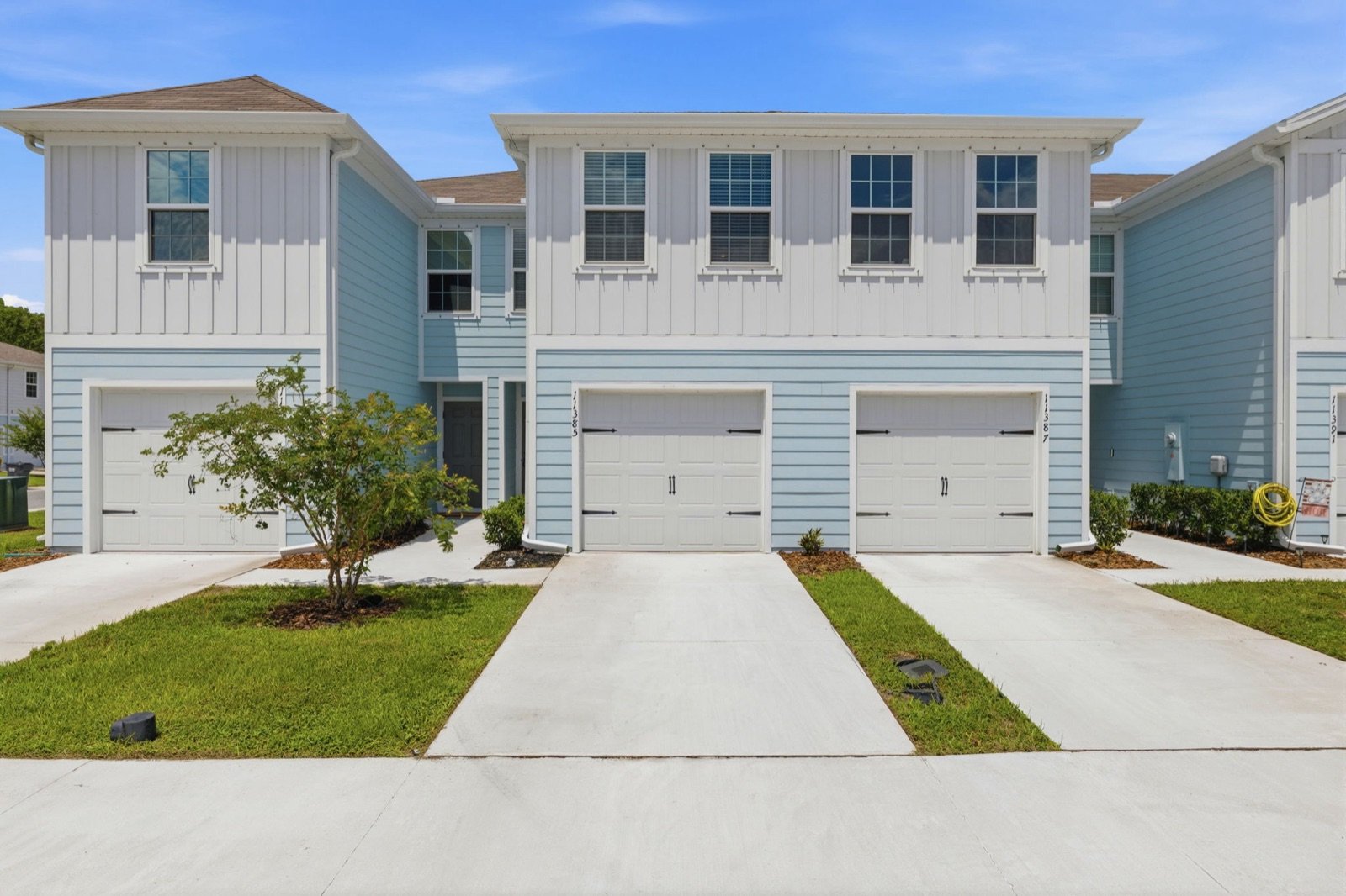 Front of a townhome with its garage and driveway